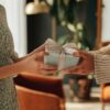 Image of man giving woman a gift for the 7 Last-Minute Mother’s Day Gifts That’ll Wow Her (And Actually Arrive on Time)
