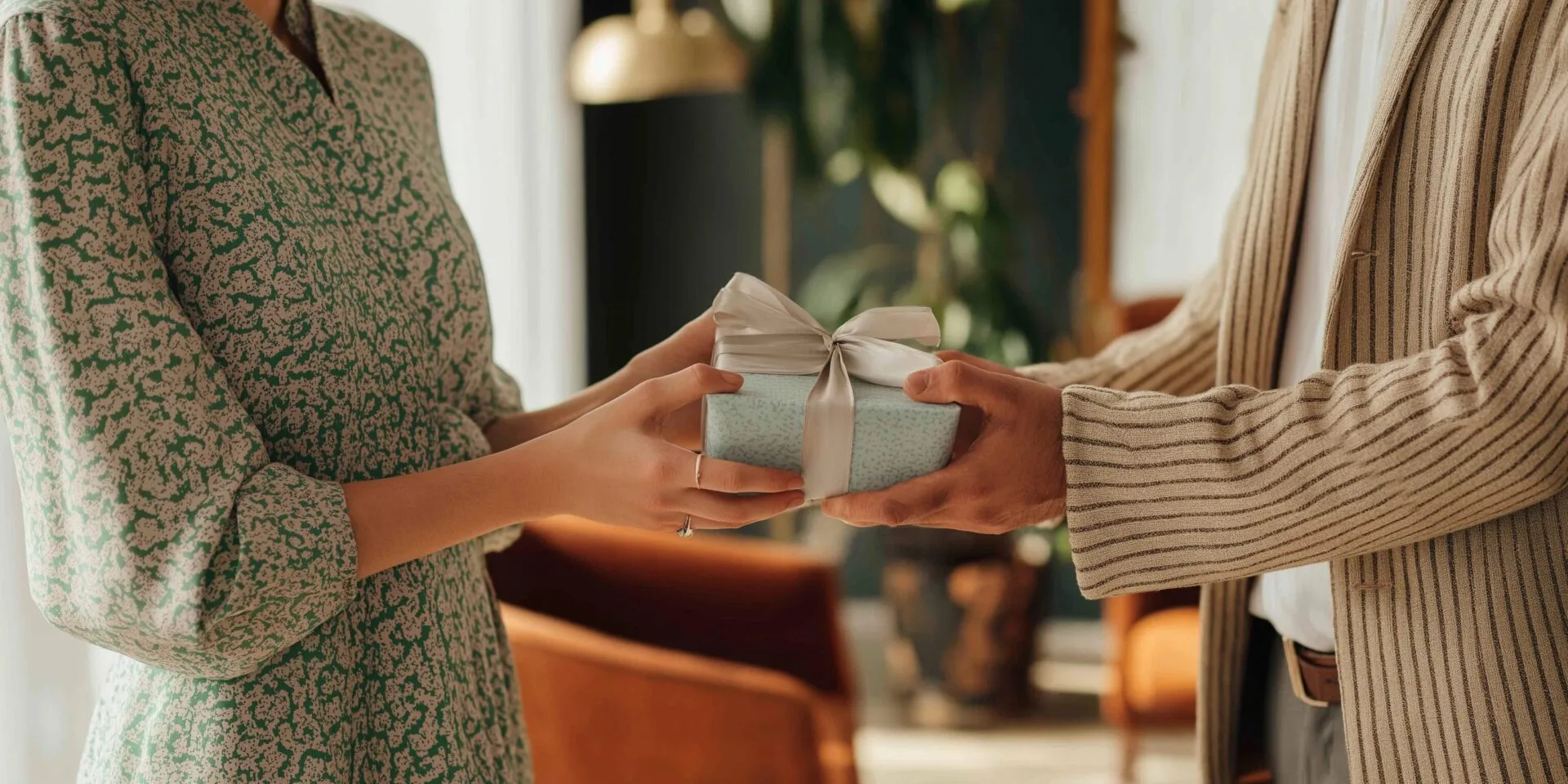 Image of man giving woman a gift for the 7 Last-Minute Mother’s Day Gifts That’ll Wow Her (And Actually Arrive on Time)