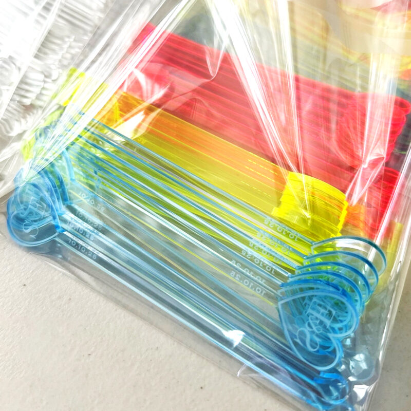 Custom wedding drink stirrers displayed elegantly on a table with wedding decorations, perfect for DIY brides saving time and adding personal touches.