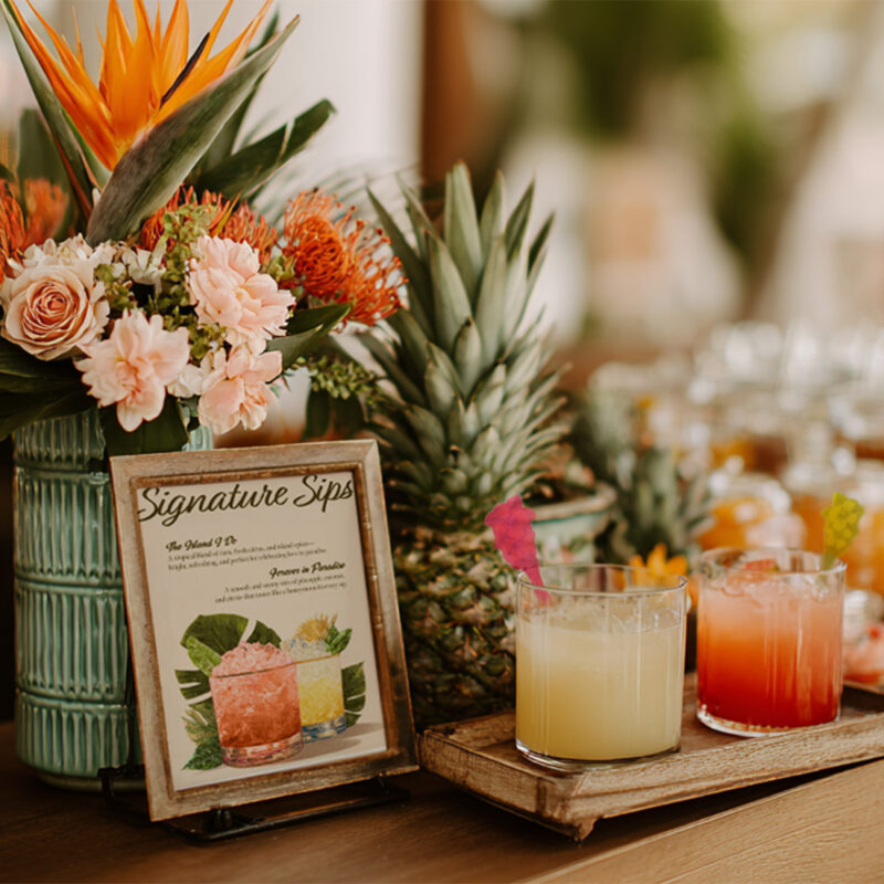 Tiki Wedding Ideas Guests Love for a Fun Tropical Celebration. Sophisticated wedding bar styling with signature wedding drinks and thoughtful details including tiki drink stirrers.