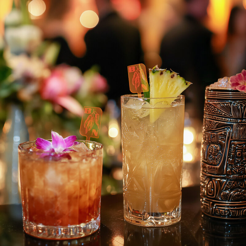 Tiki Bar Setup_ How to Brand Every Sip (And Why It Works). Custom Drink Swizzles in different cocktail glasses.
