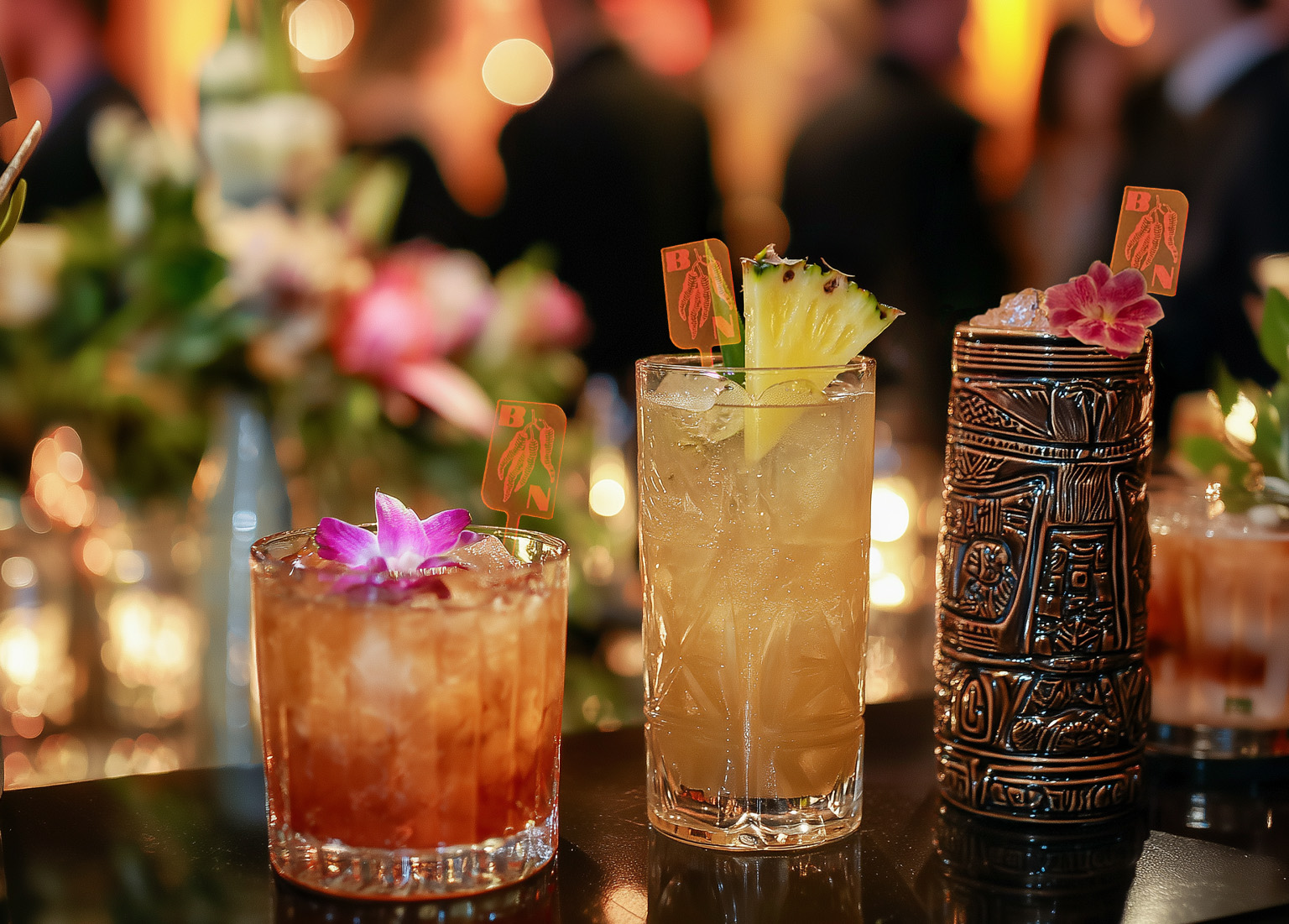 Tiki Bar Setup_ How to Brand Every Sip (And Why It Works). Custom Drink Swizzles in different cocktail glasses.
