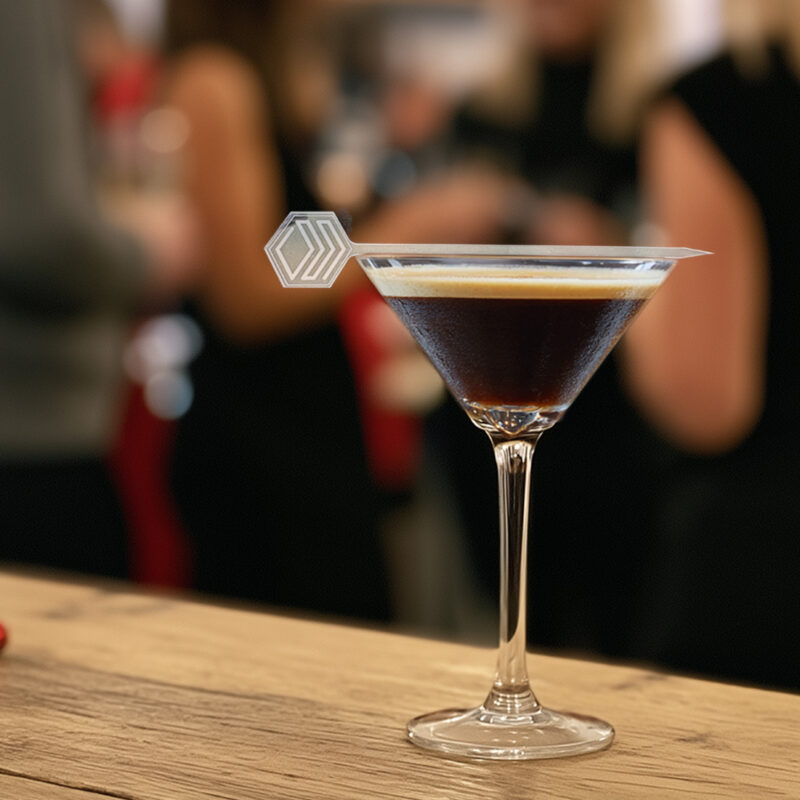 9 Ways to Make Your Corporate Holiday Party Feel More Thoughtful and On-Brand. Corporate logo on a custom garnish pick on an Espresso Martini at a Corporate Holiday Party.