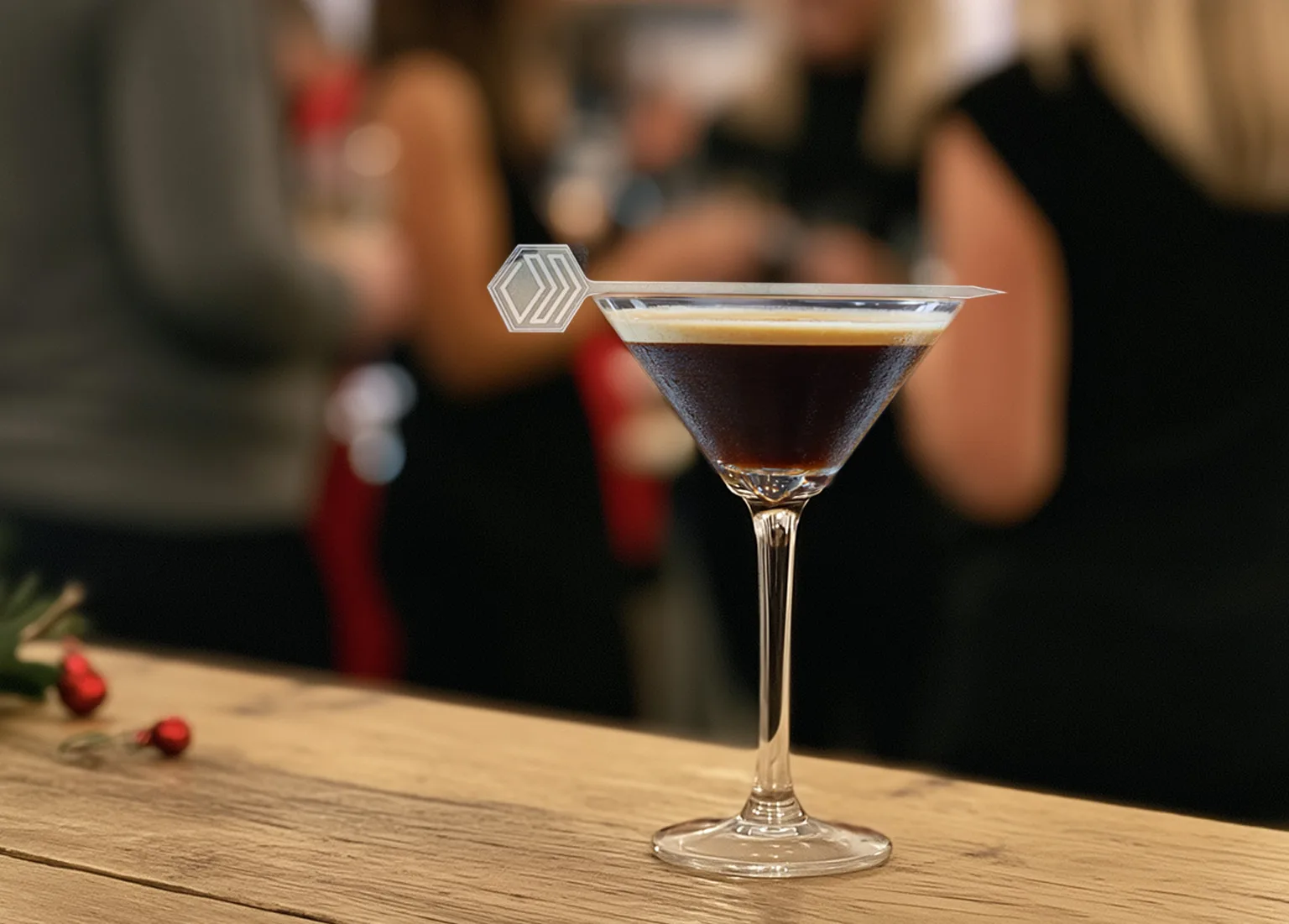 9 Ways to Make Your Corporate Holiday Party Feel More Thoughtful and On-Brand. Corporate logo on a custom garnish pick on an Espresso Martini at a Corporate Holiday Party.