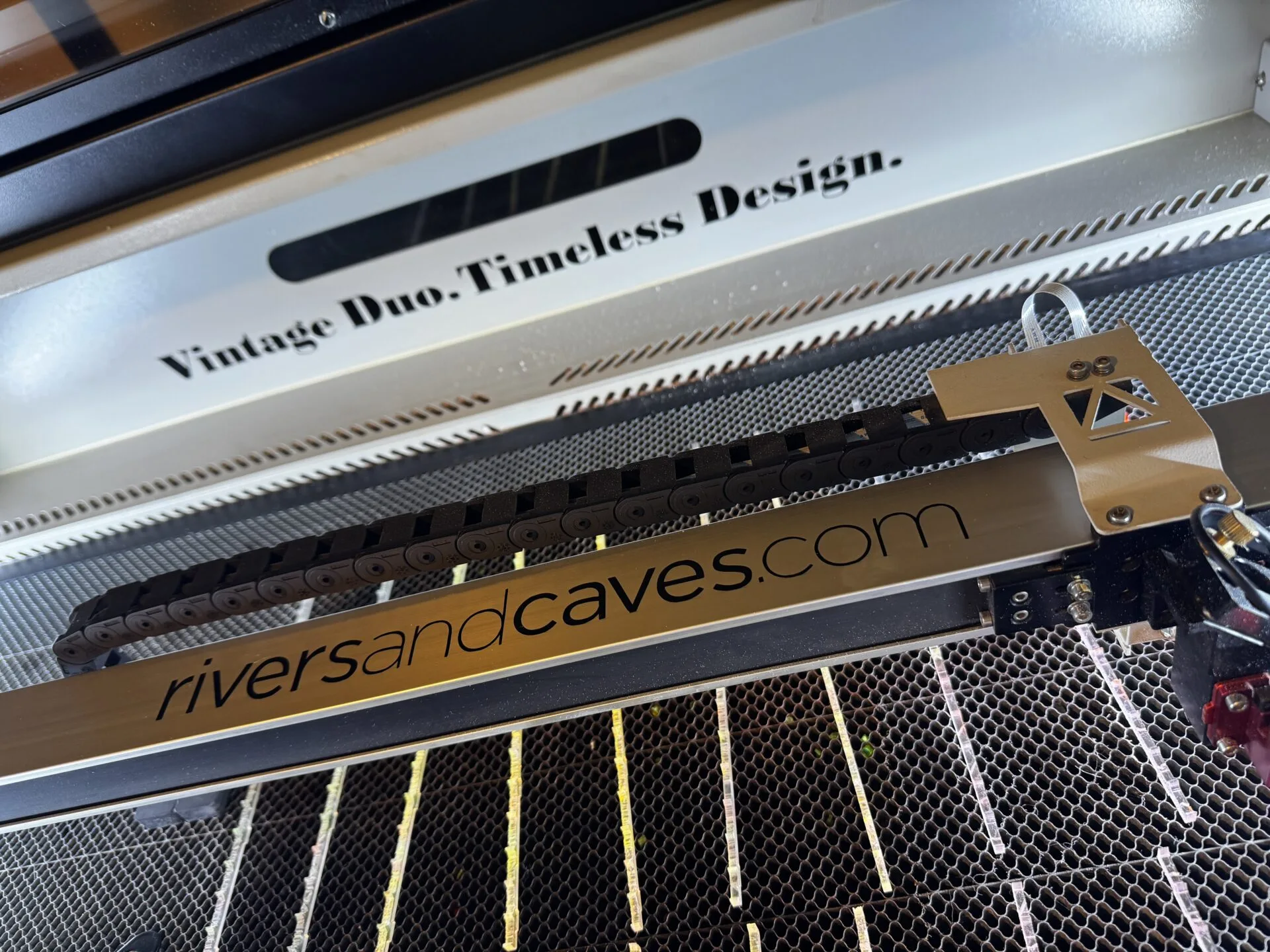 Image of a laser engraver for Rivers and Caves makers of small batch custom and personalized drink stirrers and swizzle sticks